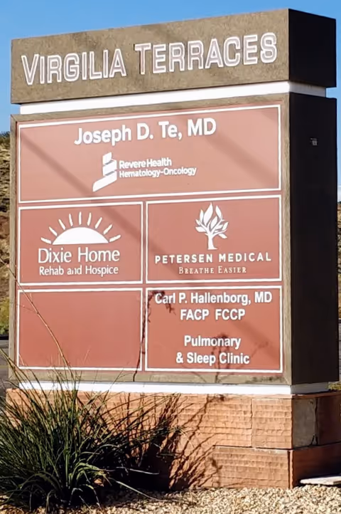 Outdoor sign displaying Dixie Home Rehab and Hospice among other medical tenants.