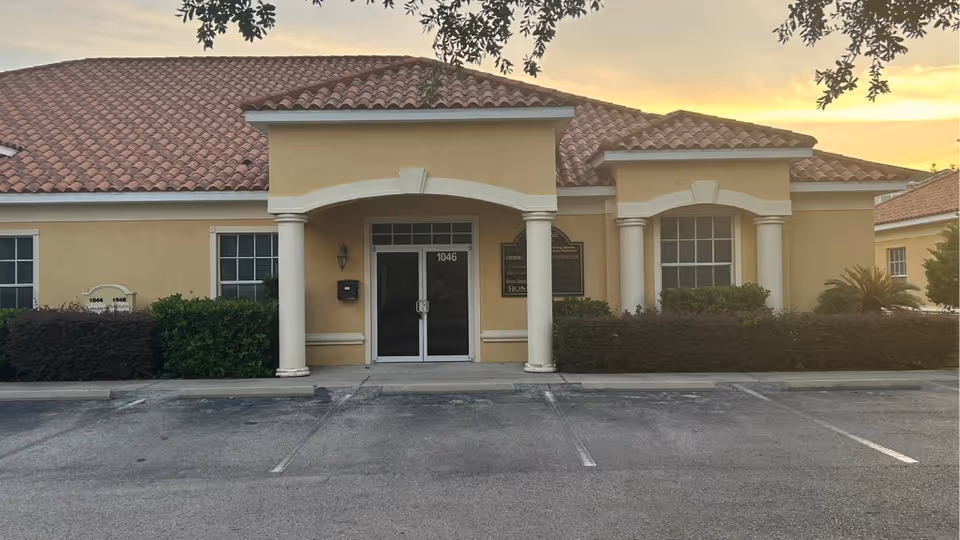 Front view of ROMET Healthcare Services building with arched entrance and columns.