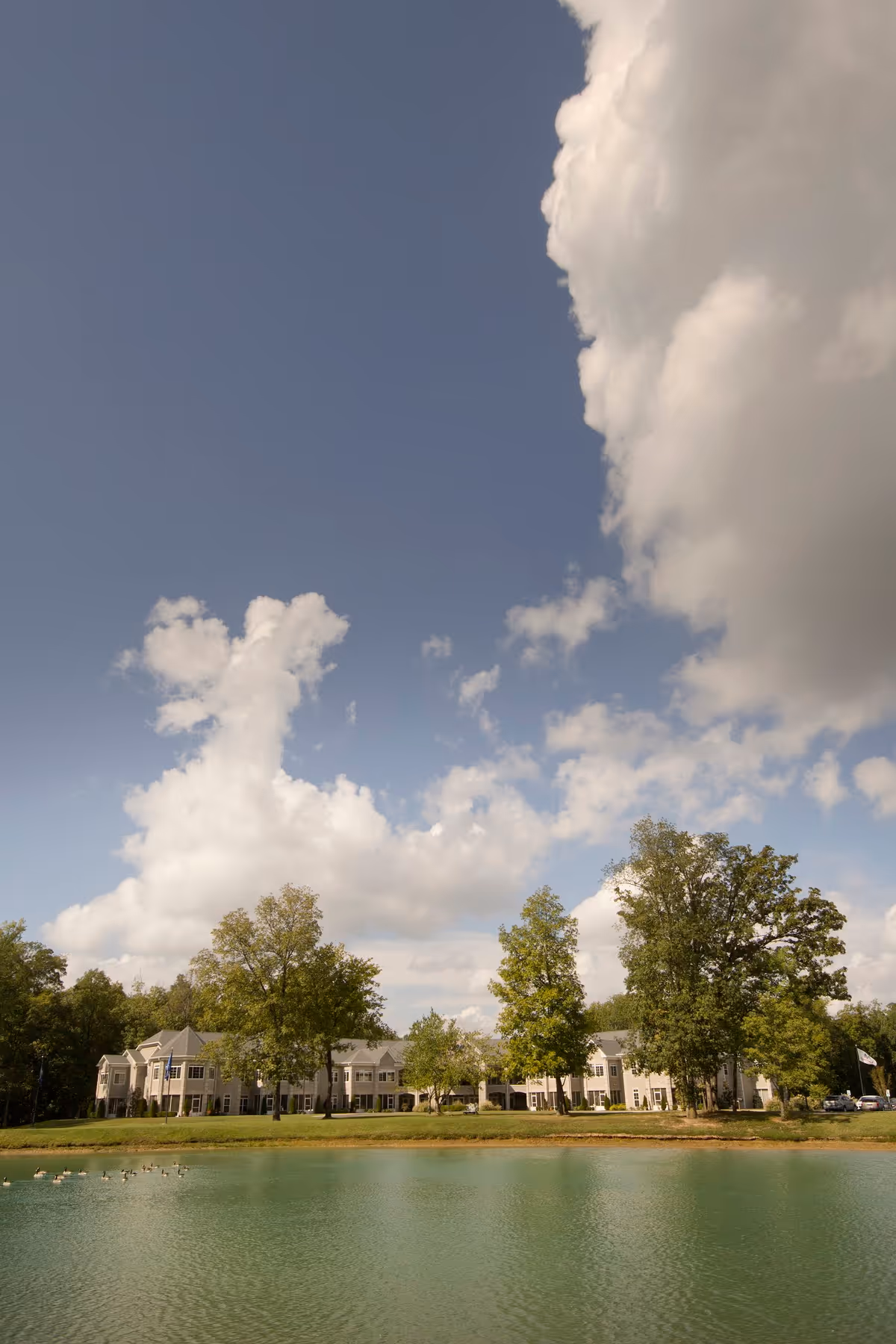 The Lakes of Paducah campus along a lakefront with trees and blue sky.