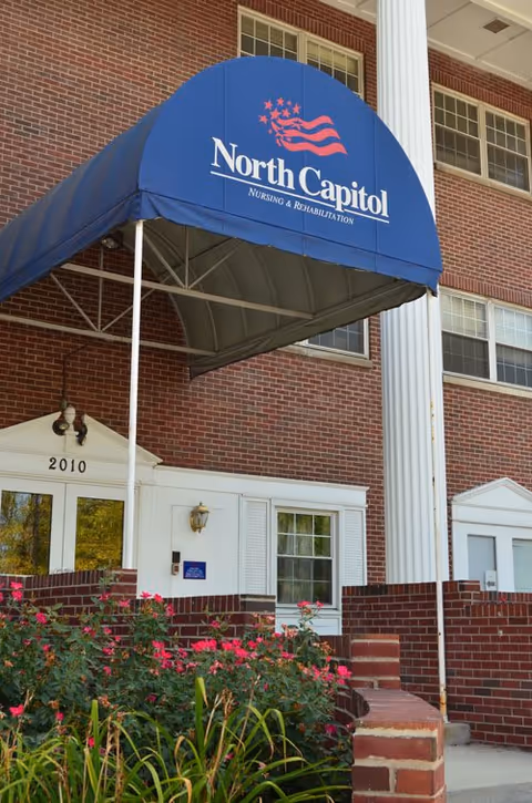 Brick building entrance with blue canopy reading North Capitol Nursing & Rehabilitation.