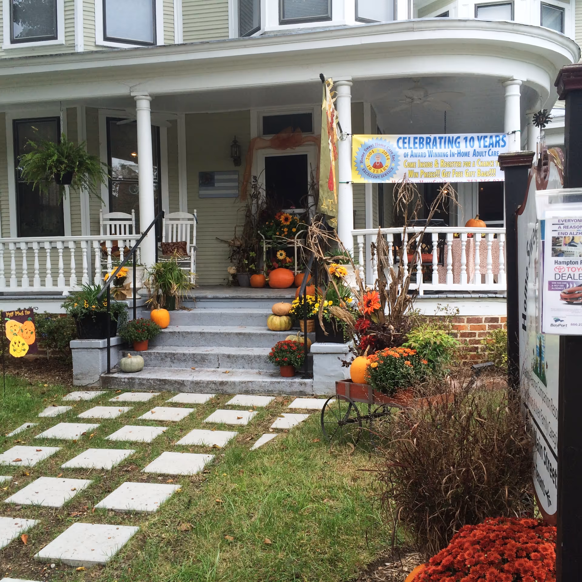 Front porch of Home Sweet Home Care with pumpkins and autumn decorations.