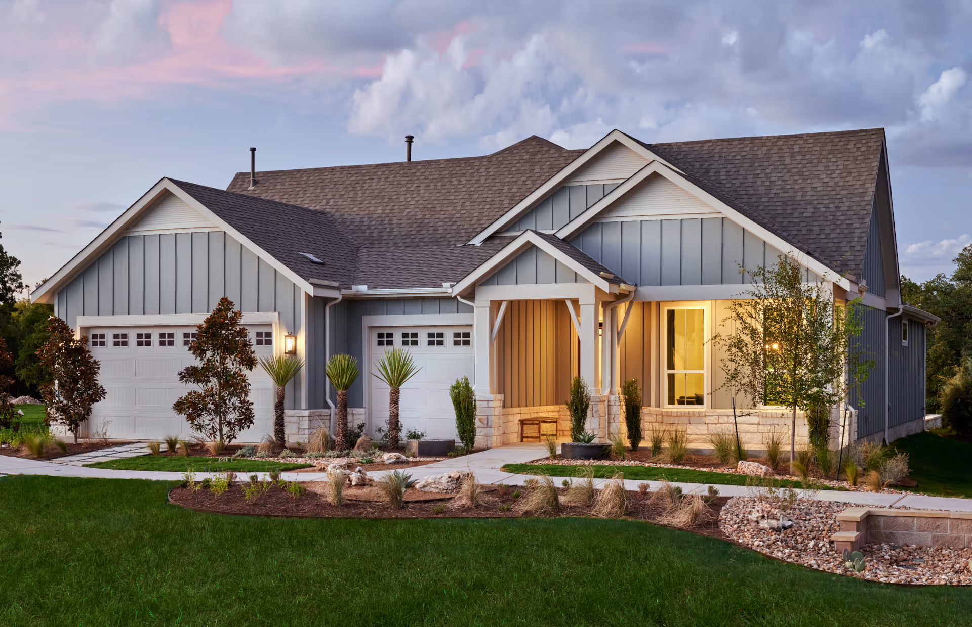 Exterior view of Sun City Texas senior living community with a landscaped front yard.