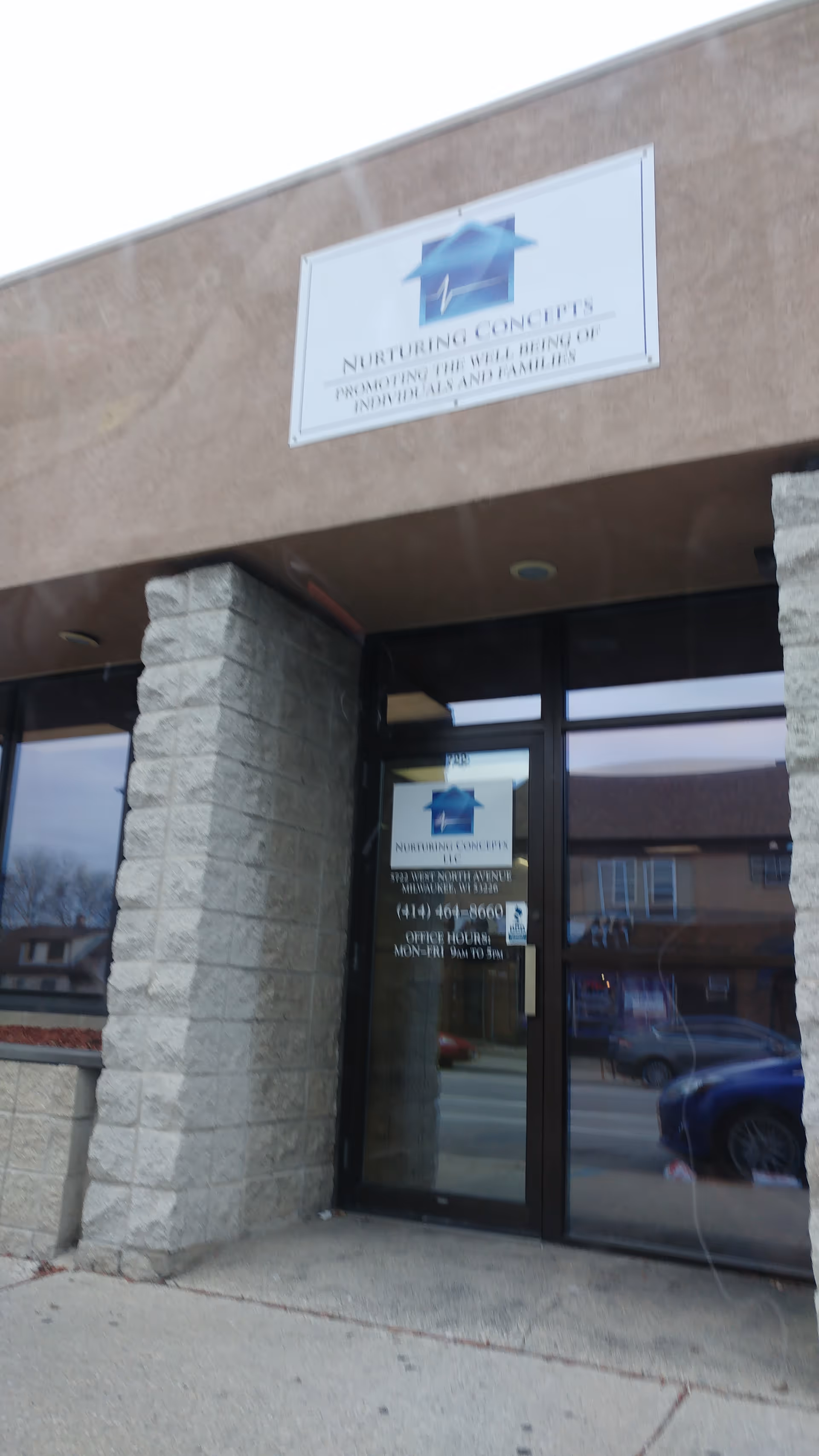 Front view of Nurturing Concepts LLC senior living facility entrance with sign.