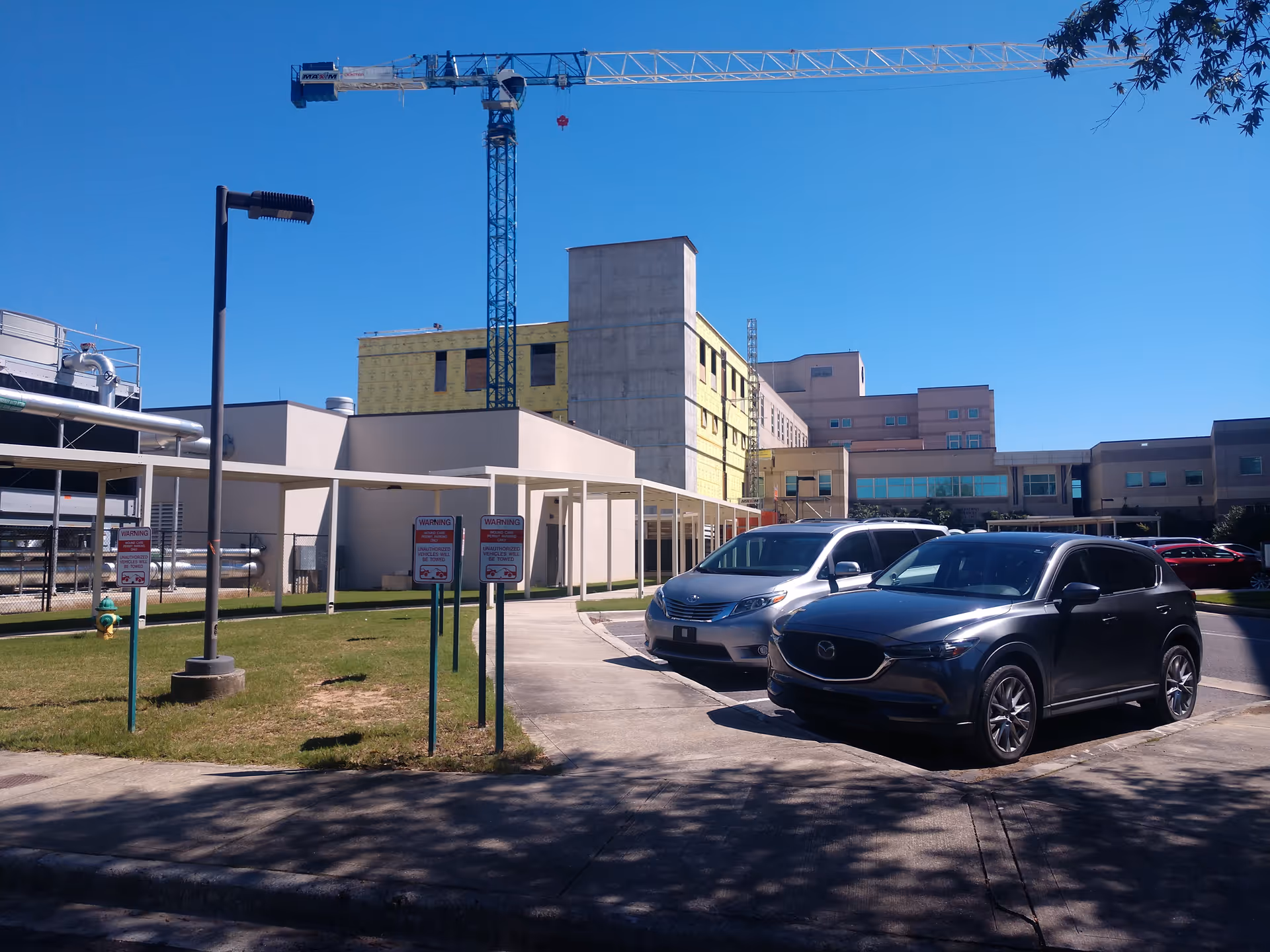 Exterior view of Cullman Regional Medical Center under construction with a crane