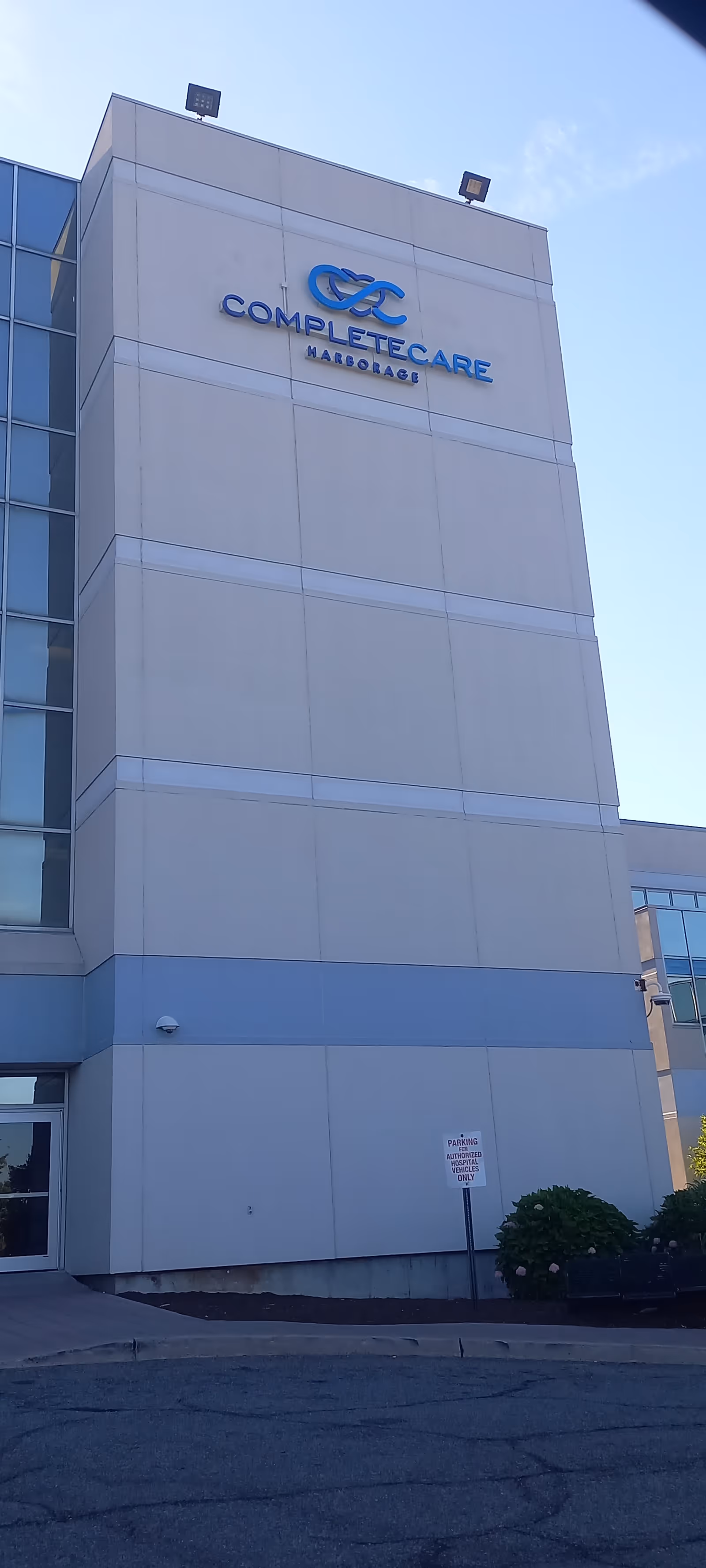 Exterior of a modern senior living building with CompleteCare Harborage signage.