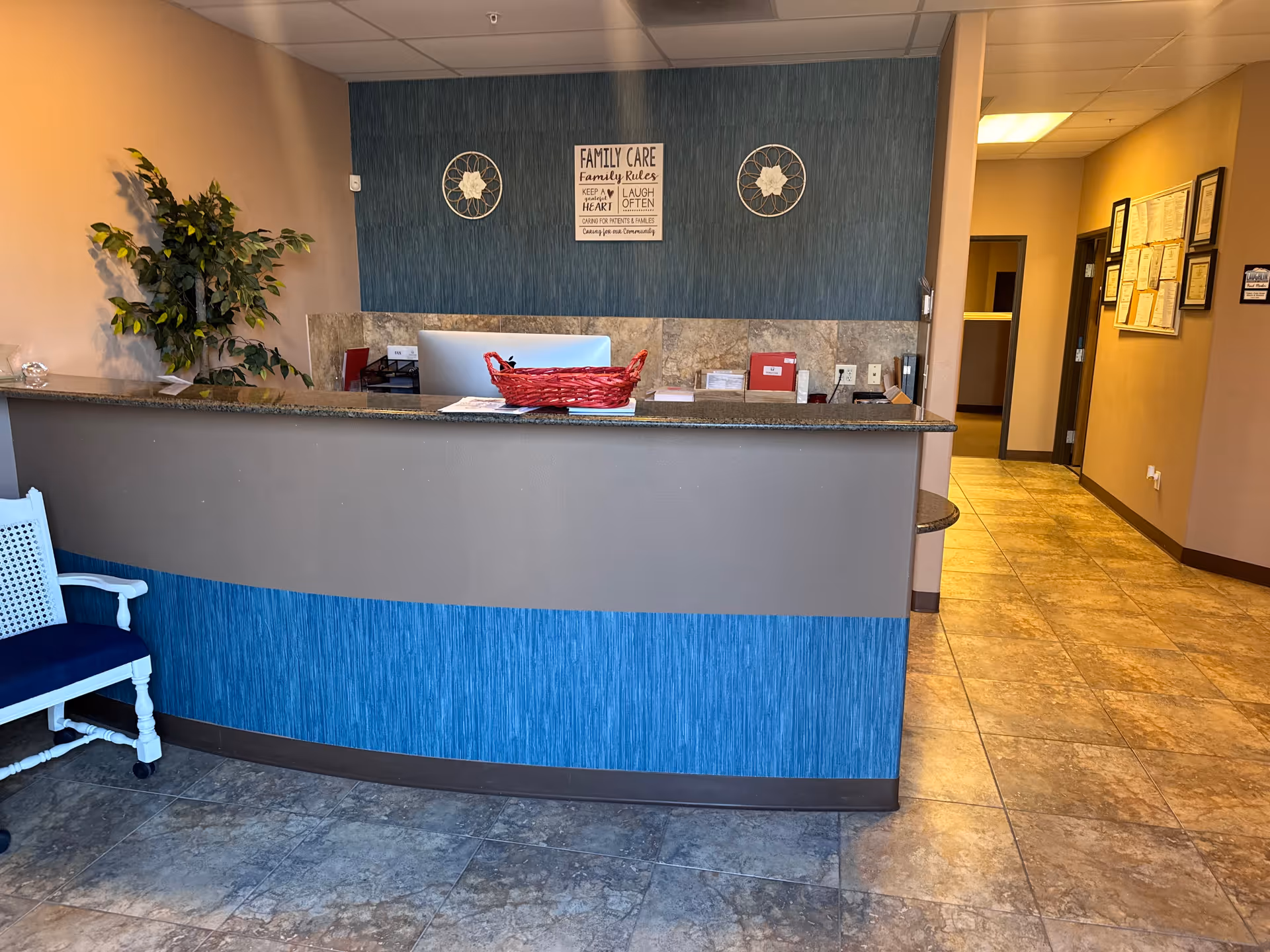 Reception desk area in a senior care facility lobby with blue accents.