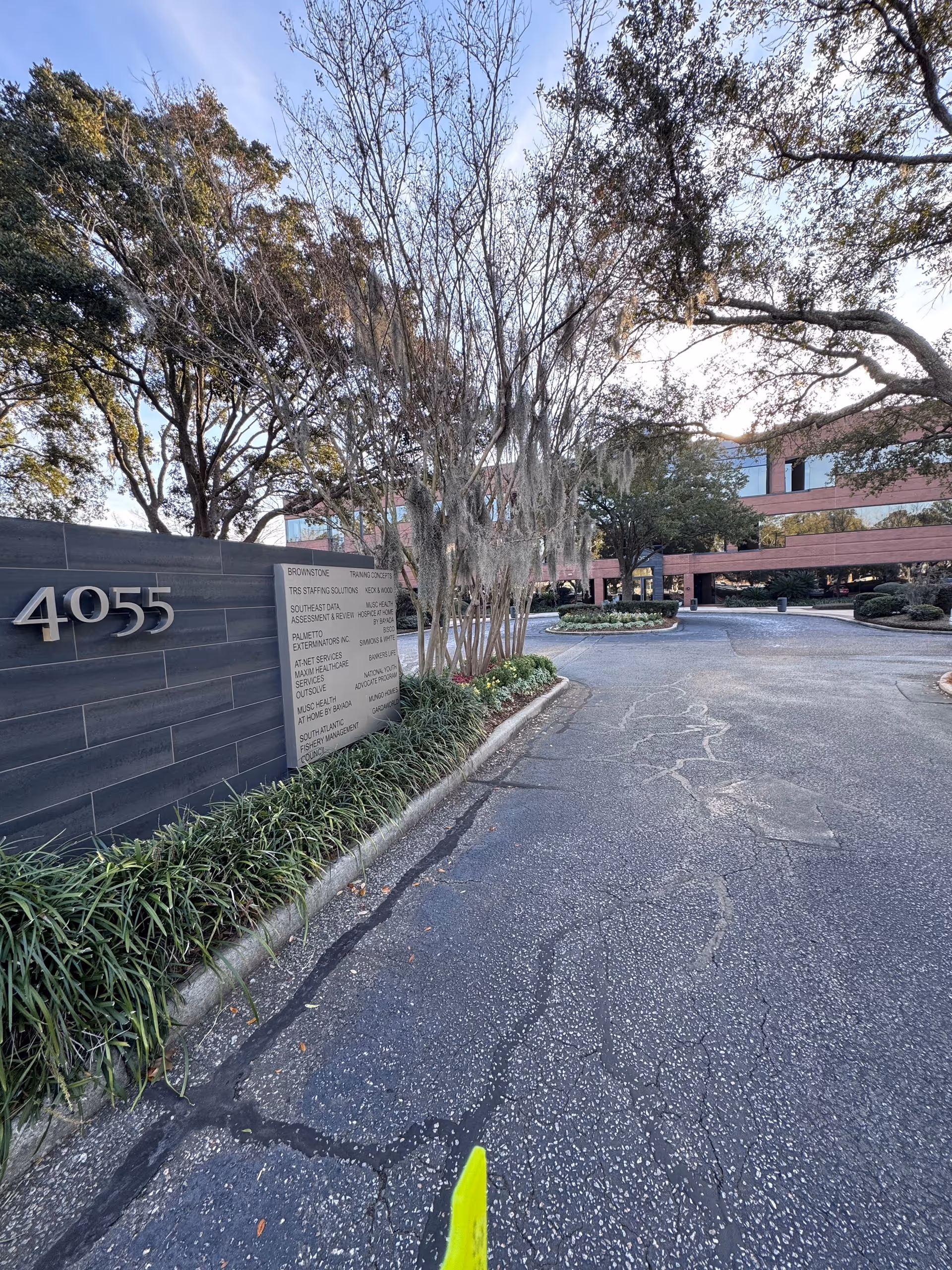 Exterior view of a senior facility entrance with address 4055 and landscaped driveway.