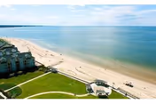 Aerial view of Westminster-Canterbury on Chesapeake Bay, showing beach, lawn, and shoreline.