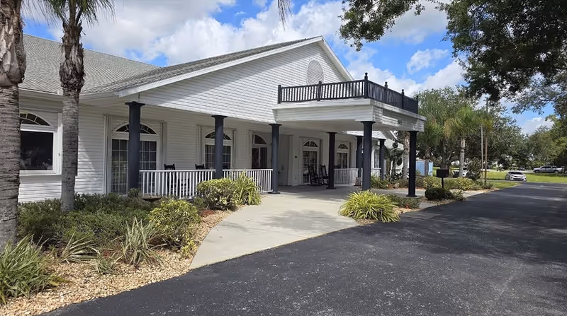 Exterior view of Arcadia Oaks Assisted Living with a covered entry and landscaping.