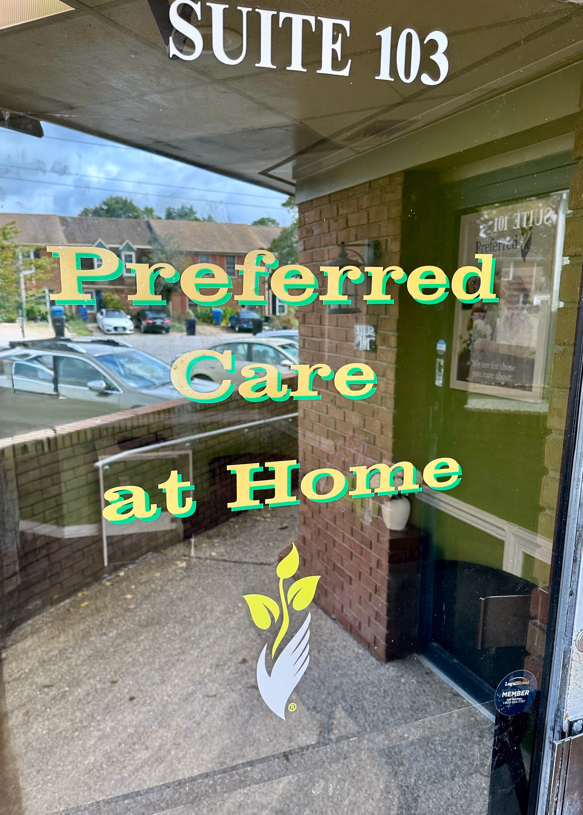 Glass storefront showing 'Preferred Care at Home' lettering and 'Suite 103' above.