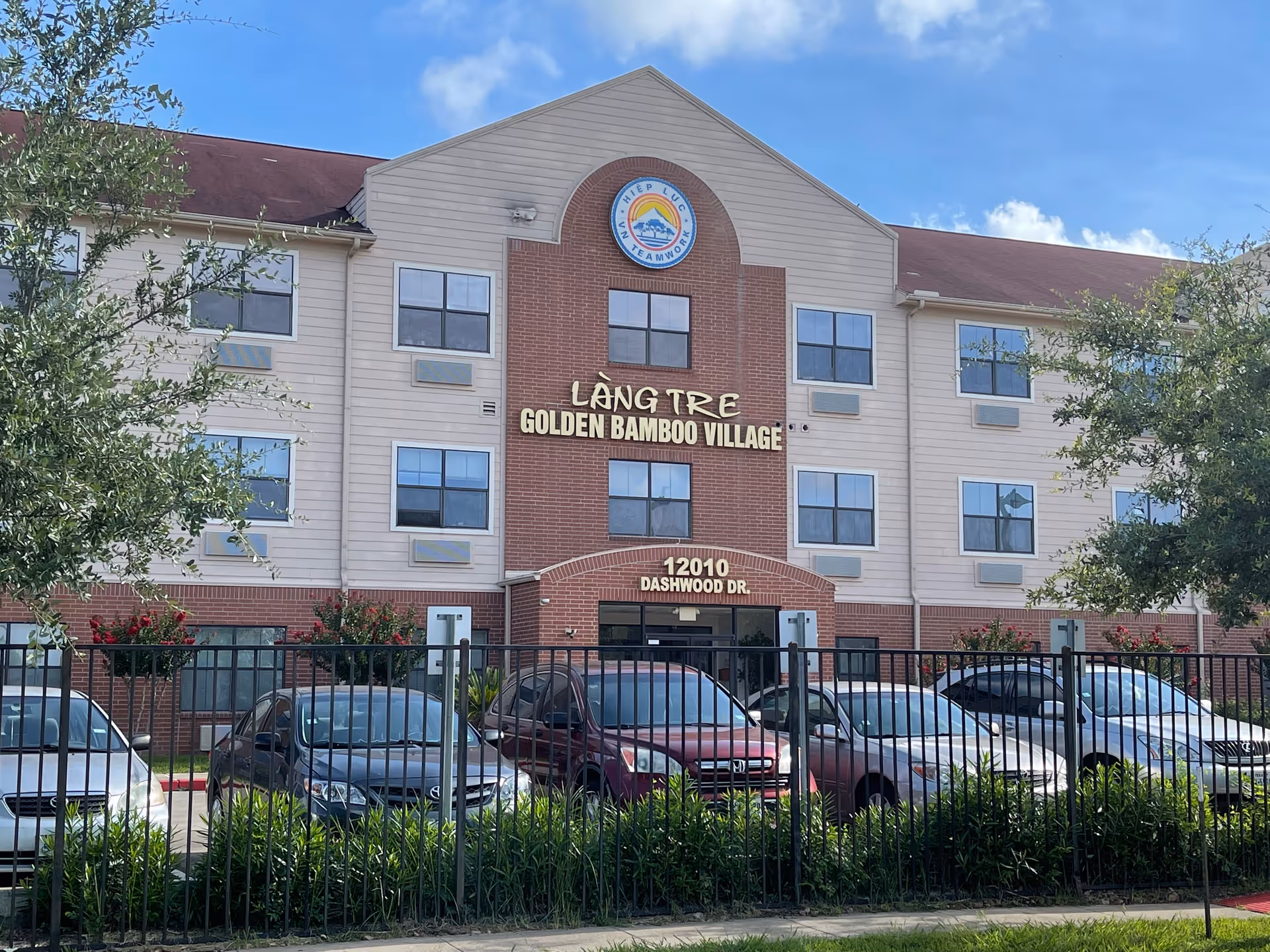 Exterior view of Golden Bamboo Village senior living building with front parking.
