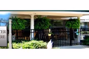 Exterior entrance of Goodwater Healthcare Center with columns and hanging plants.