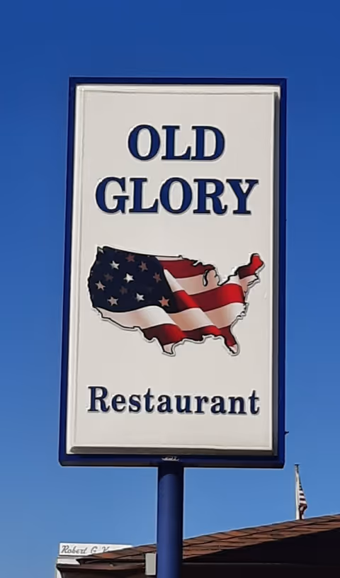 Outdoor sign reads Old Glory Restaurant with a map of the United States.