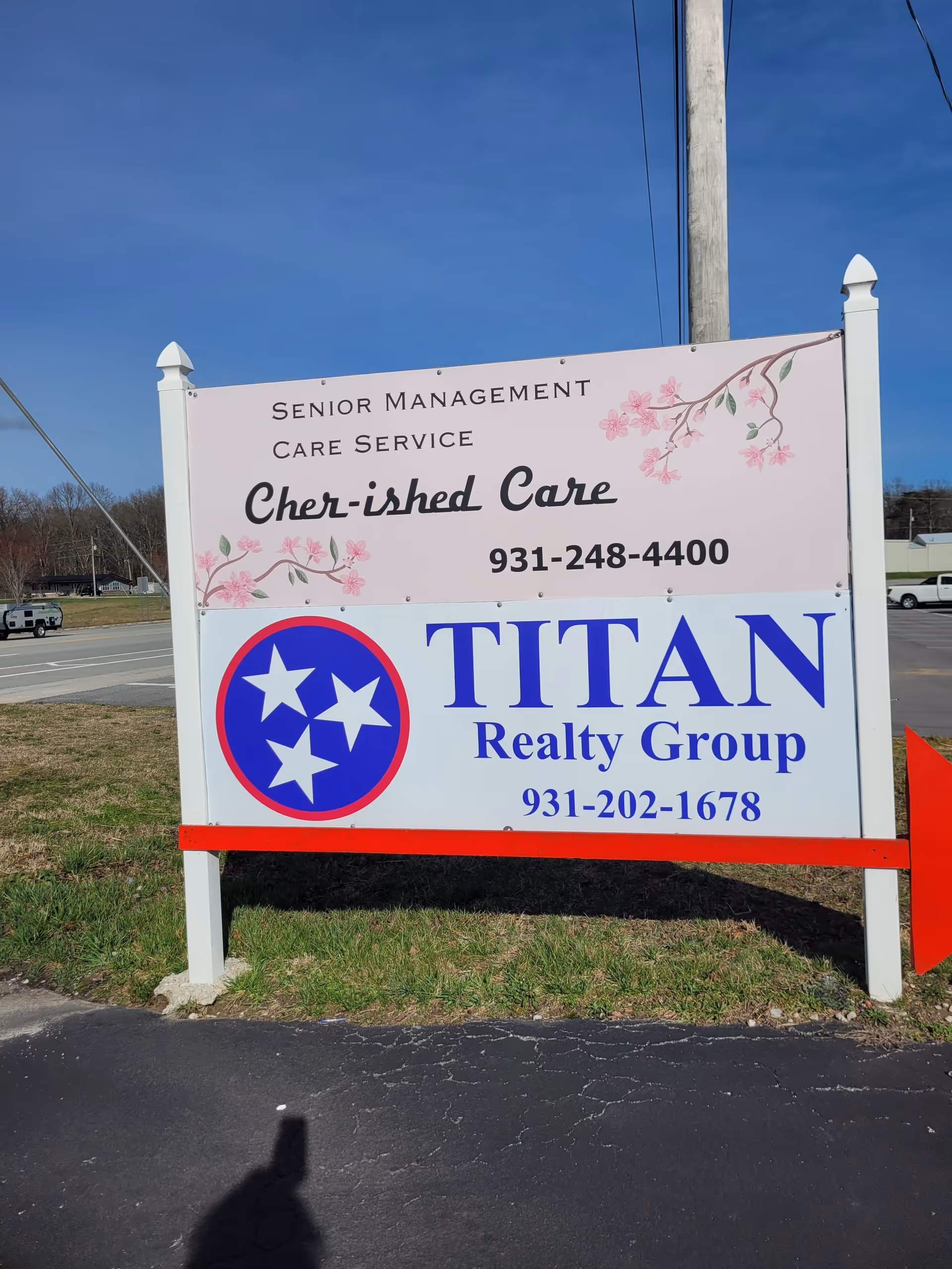 Outdoor sign announces Cher-ished Care senior services with Titan Realty branding.