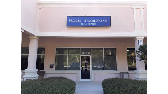 Facade of Brooks Rehabilitation Home Health entrance with glass doors and blue sign.