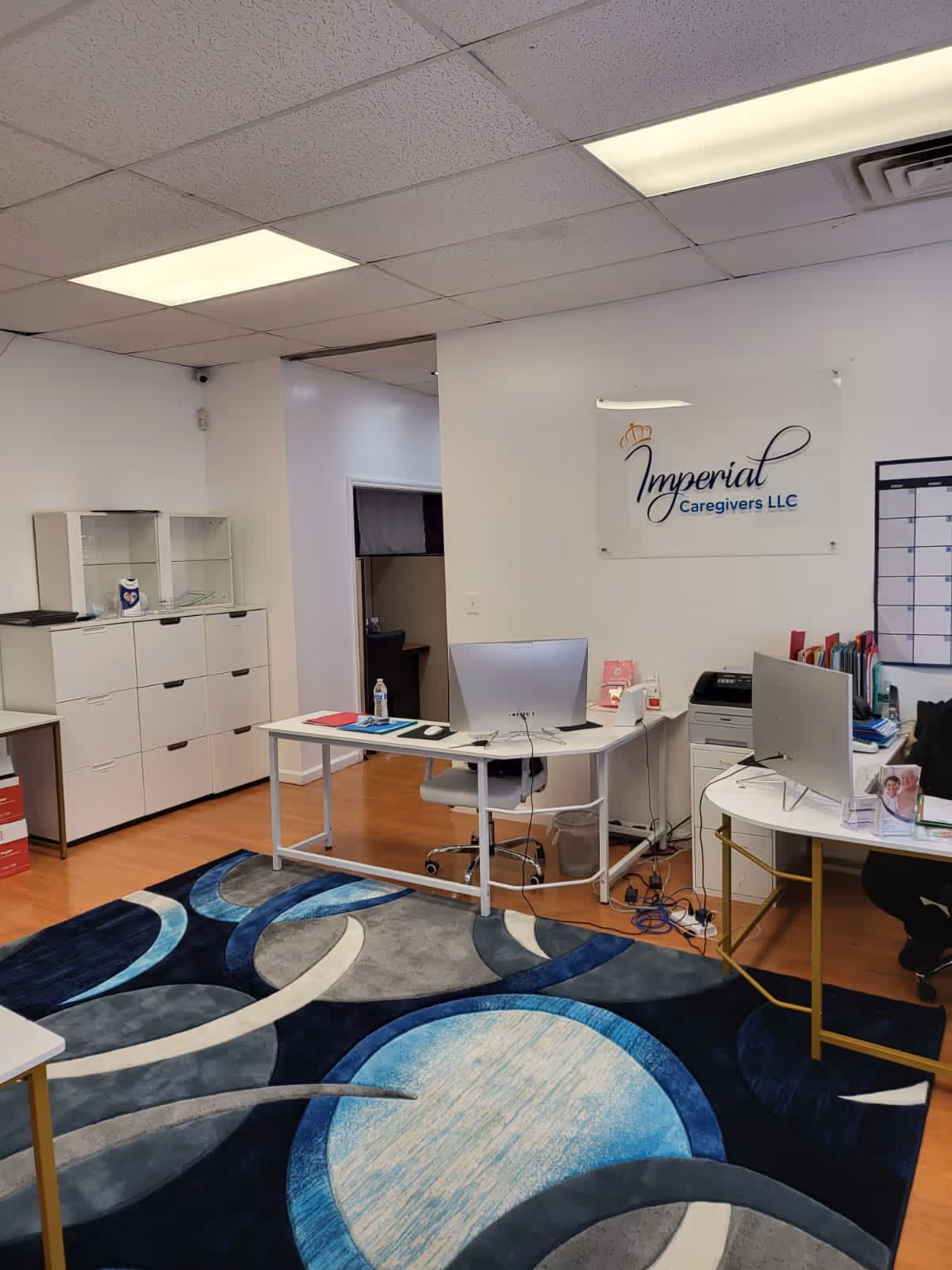 Office reception area with desks, computers, and an Imperial Caregivers sign.