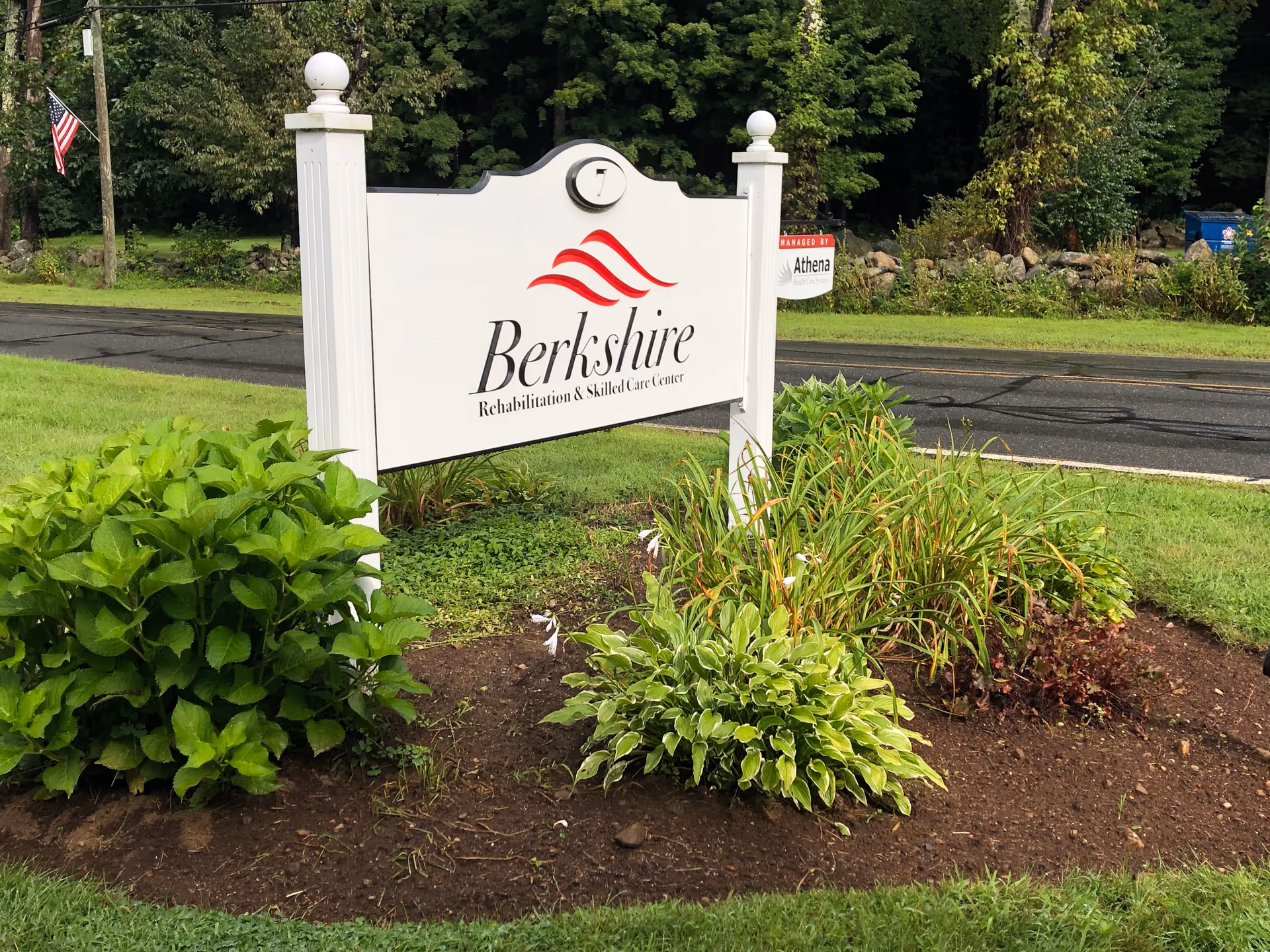 A Berkshire sign in a landscaped yard along a road.