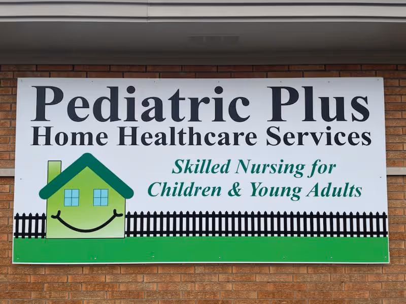 Large sign on brick wall reading Pediatric Plus Home Healthcare Services