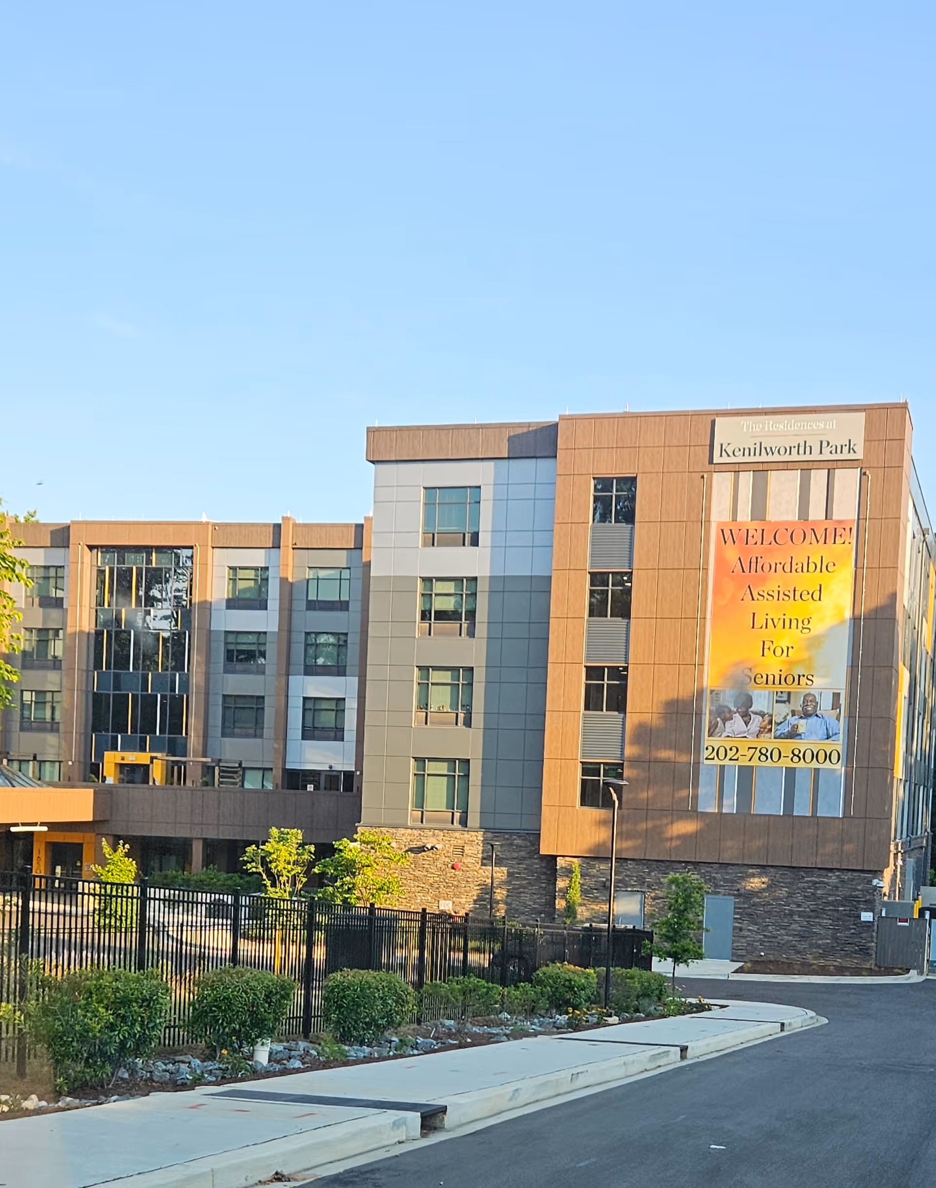 Exterior view of The Residences at Kenilworth Park building with a welcome banner.