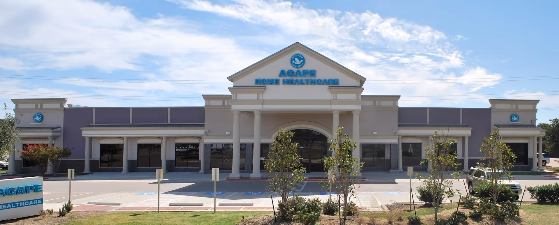 Exterior view of Agape Home Healthcare building with parking and landscaping.