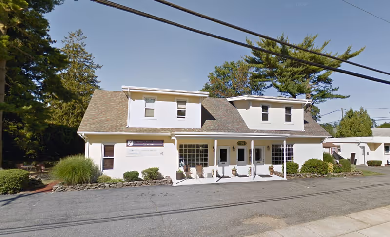 Front view of CareBridge Home Care building with a small porch and shrubs.