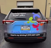 Rear view of a Penn Home Care vehicle with logo, multilingual text, and phone number.