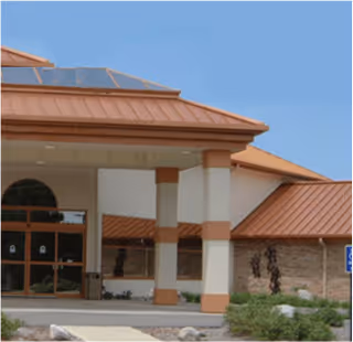 Exterior entrance to Lighthouse Rehabilitation Traverse City Therapy with orange roof and columns.