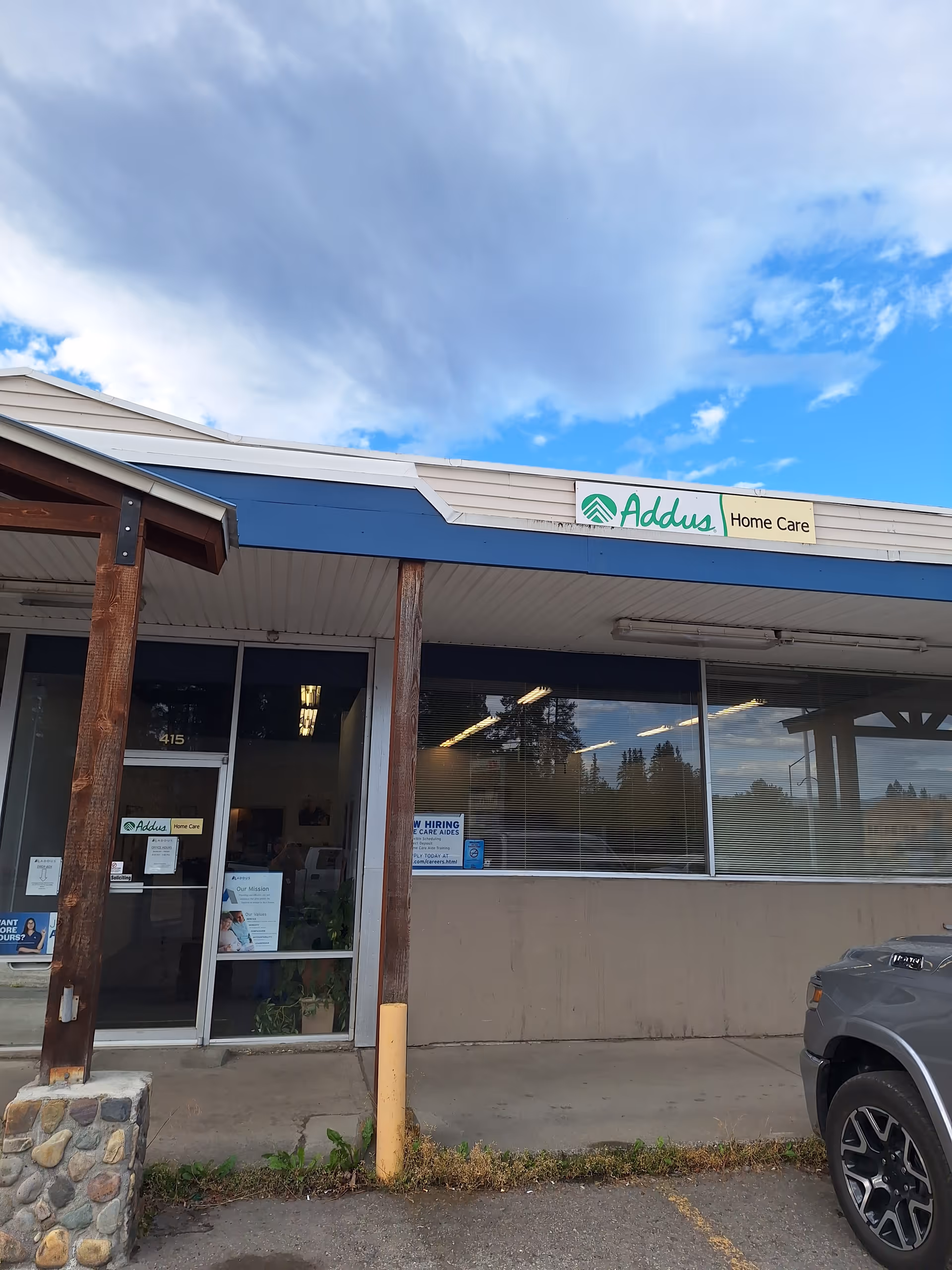 Exterior view of Addus Home Care storefront with large windows and front entrance.