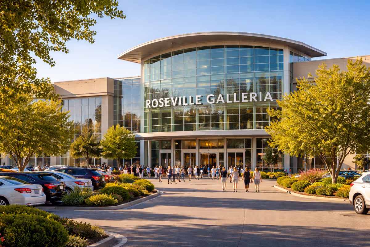 Modern mall exterior with glass facade and crowds entering Roseville Galleria.