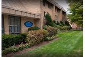 Exterior view of Trinity Hill Care Center with neatly trimmed lawn and shrubs.
