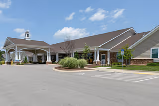 Exterior view of The Harpeth at Harmony Hills with a covered entrance and landscaping.