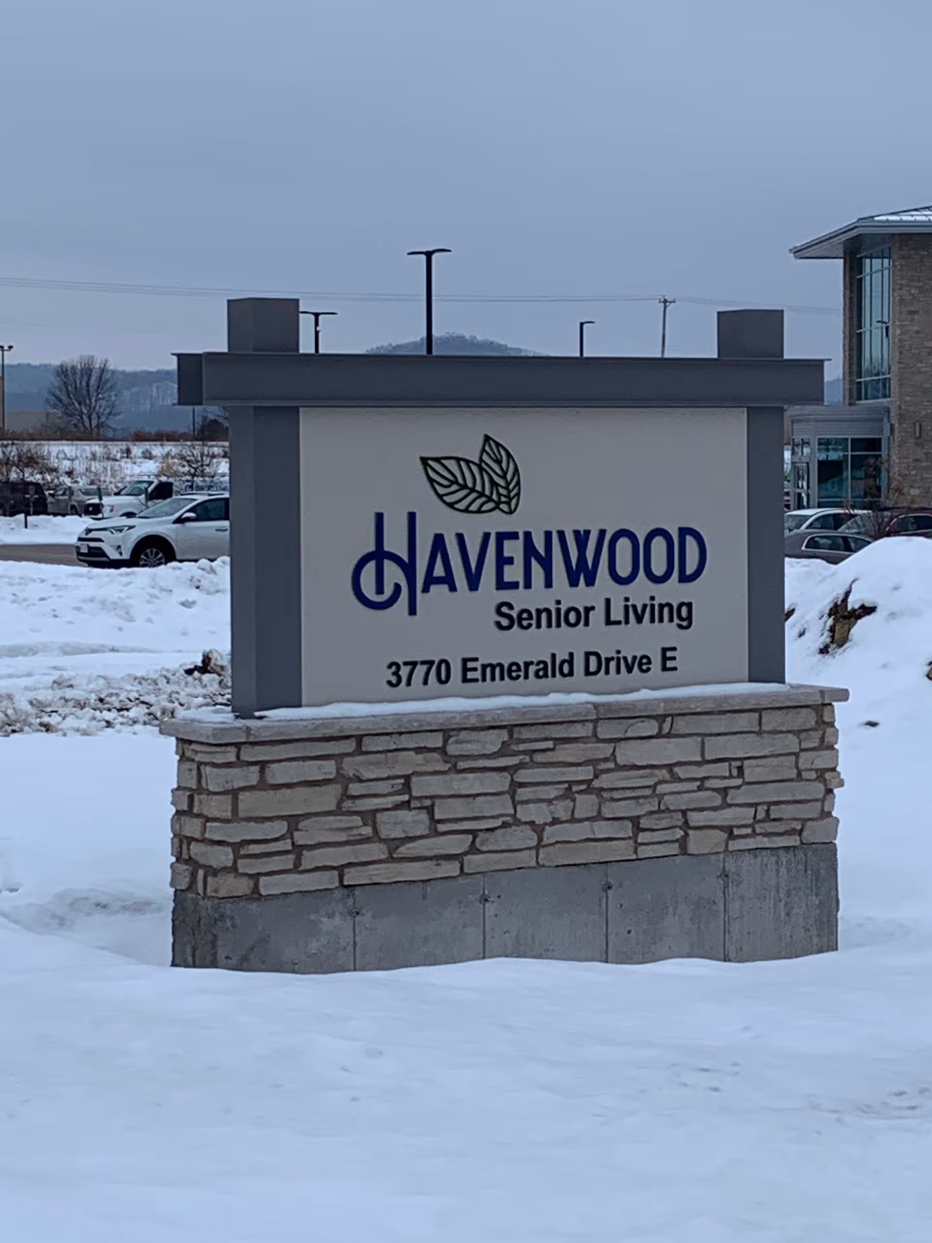 Freestanding outdoor sign for Havenwood Senior Living (3770 Emerald Drive E) in a snowy front lot.