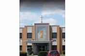 Exterior view of Misericordia Nursing & Rehabilitation Center with central entrance and cross.