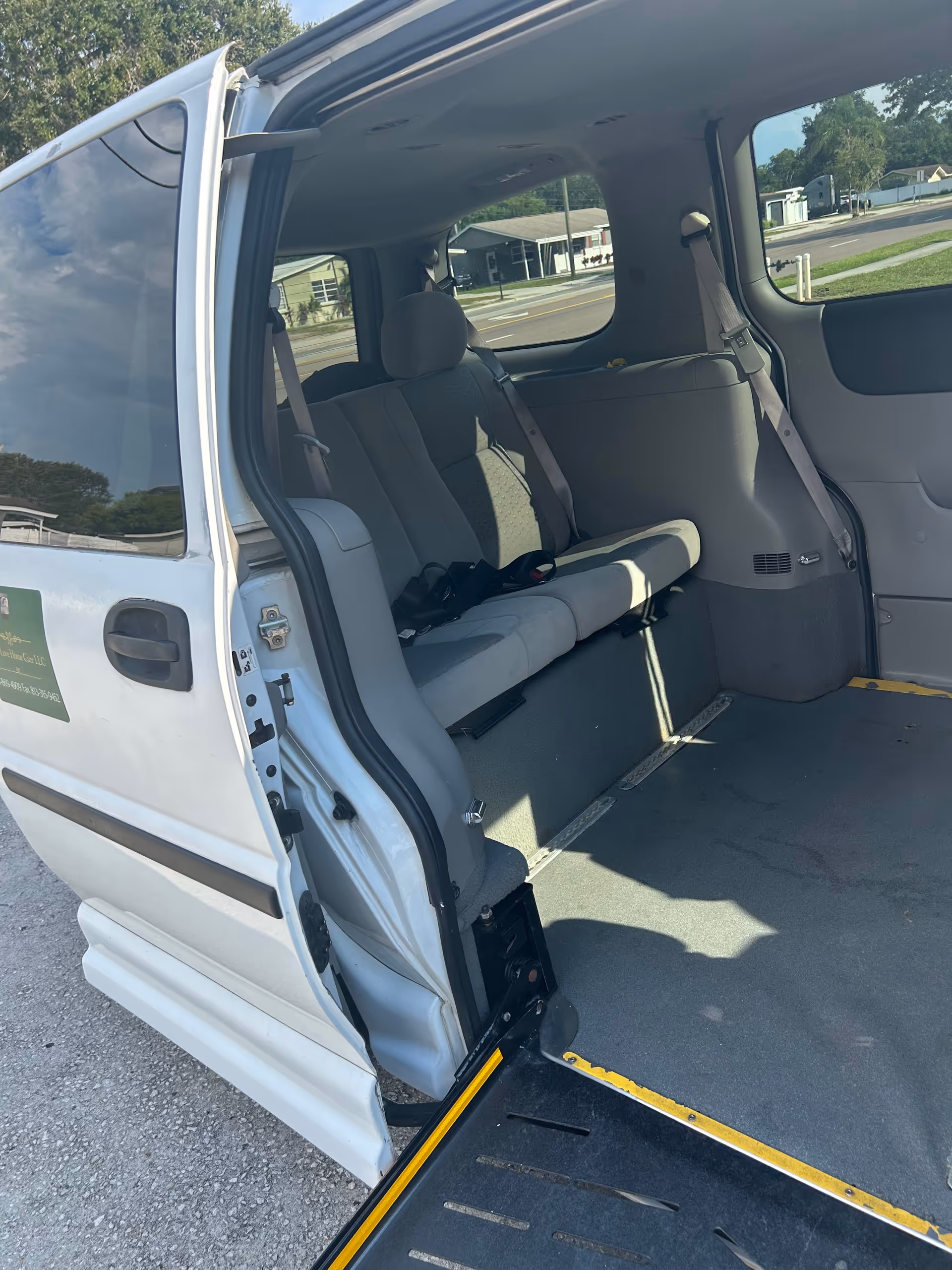 Open van with wheelchair ramp, showing empty passenger seats inside a senior transport vehicle.