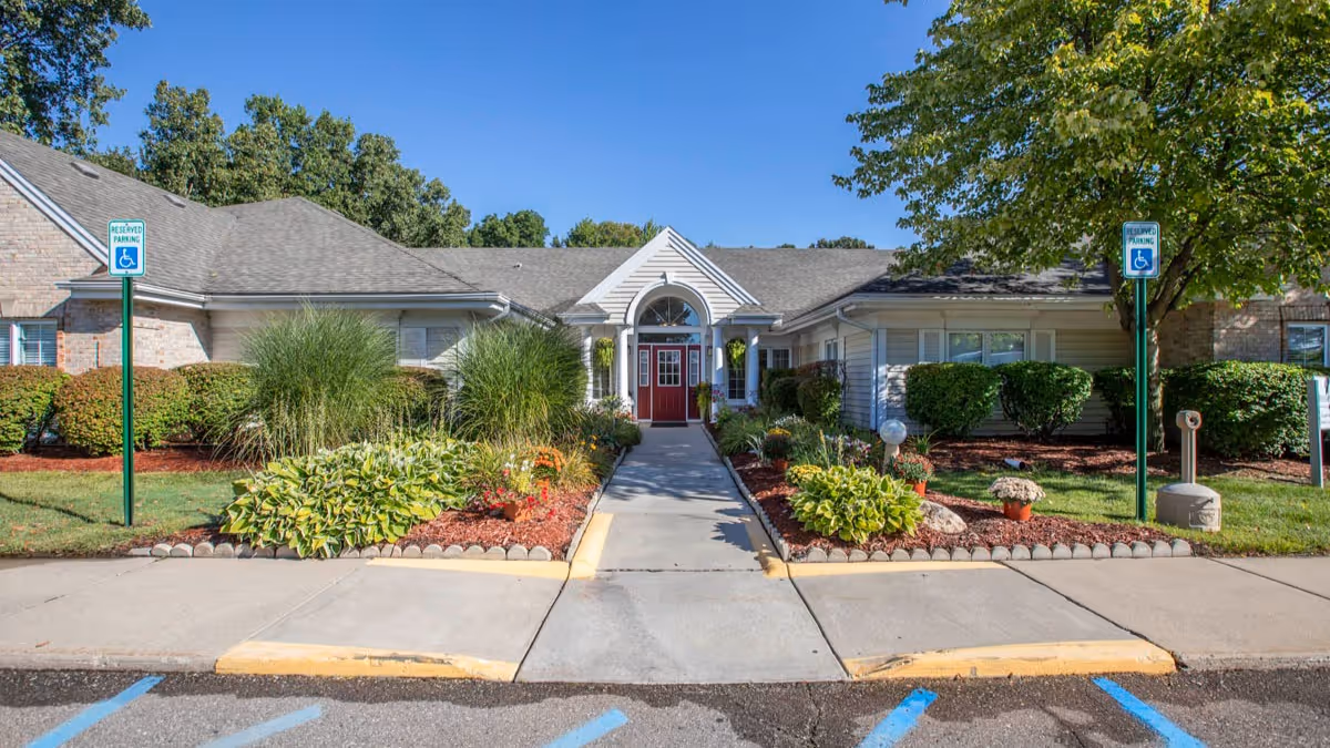 Front view of Brookdale Utica senior living center with landscaped entrance and parking.