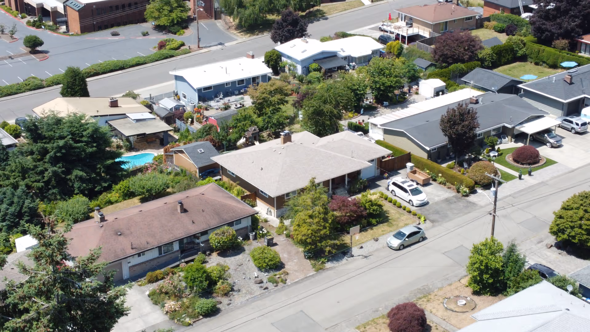 Aerial view of a residential neighborhood with single-family homes and trees.