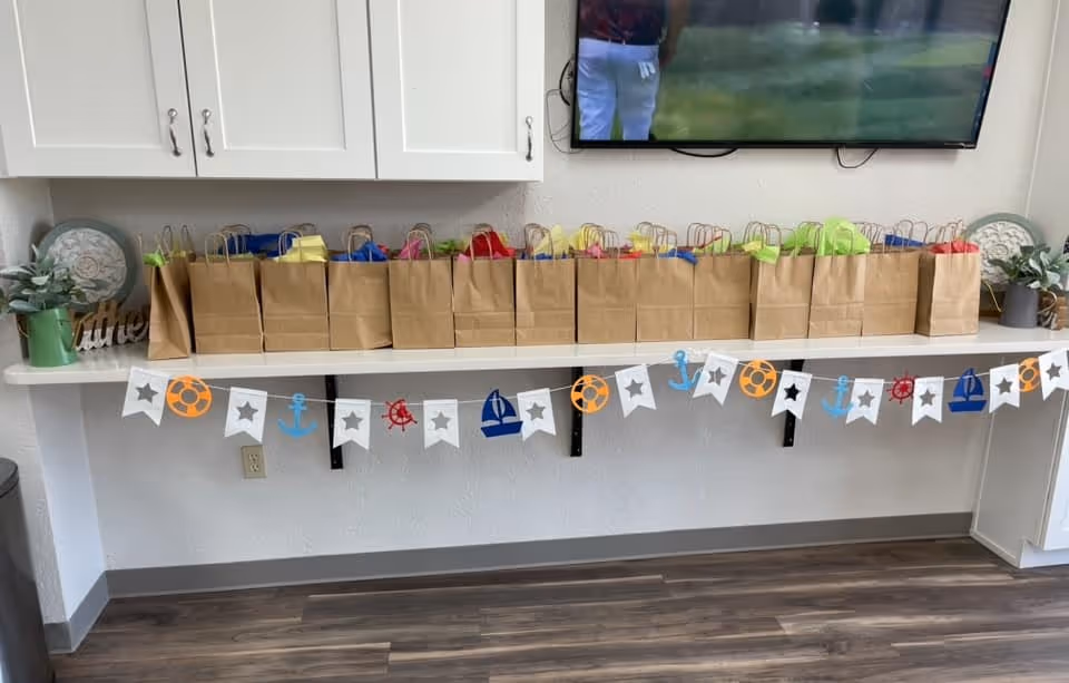 Row of brown gift bags with colorful tissue on a counter inside Parkview Big Spring.
