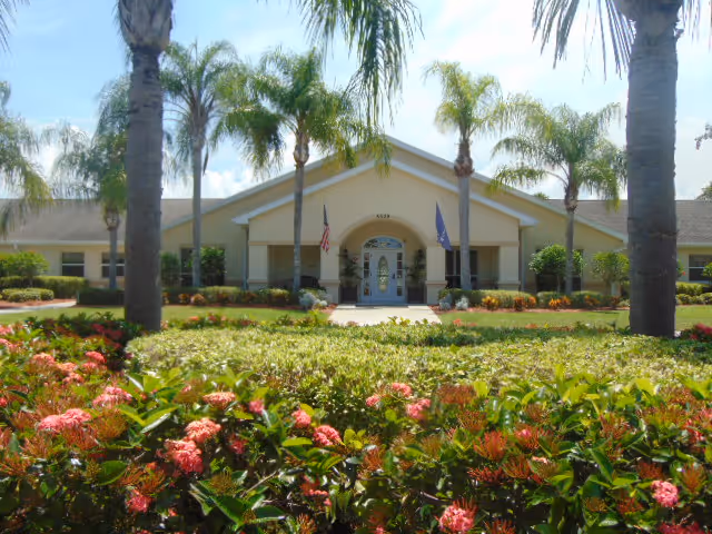 Front view of Arden Courts Seminole with palm trees and landscaped entrance.