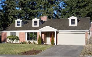 Residential single-story home with a two-car garage and front yard.