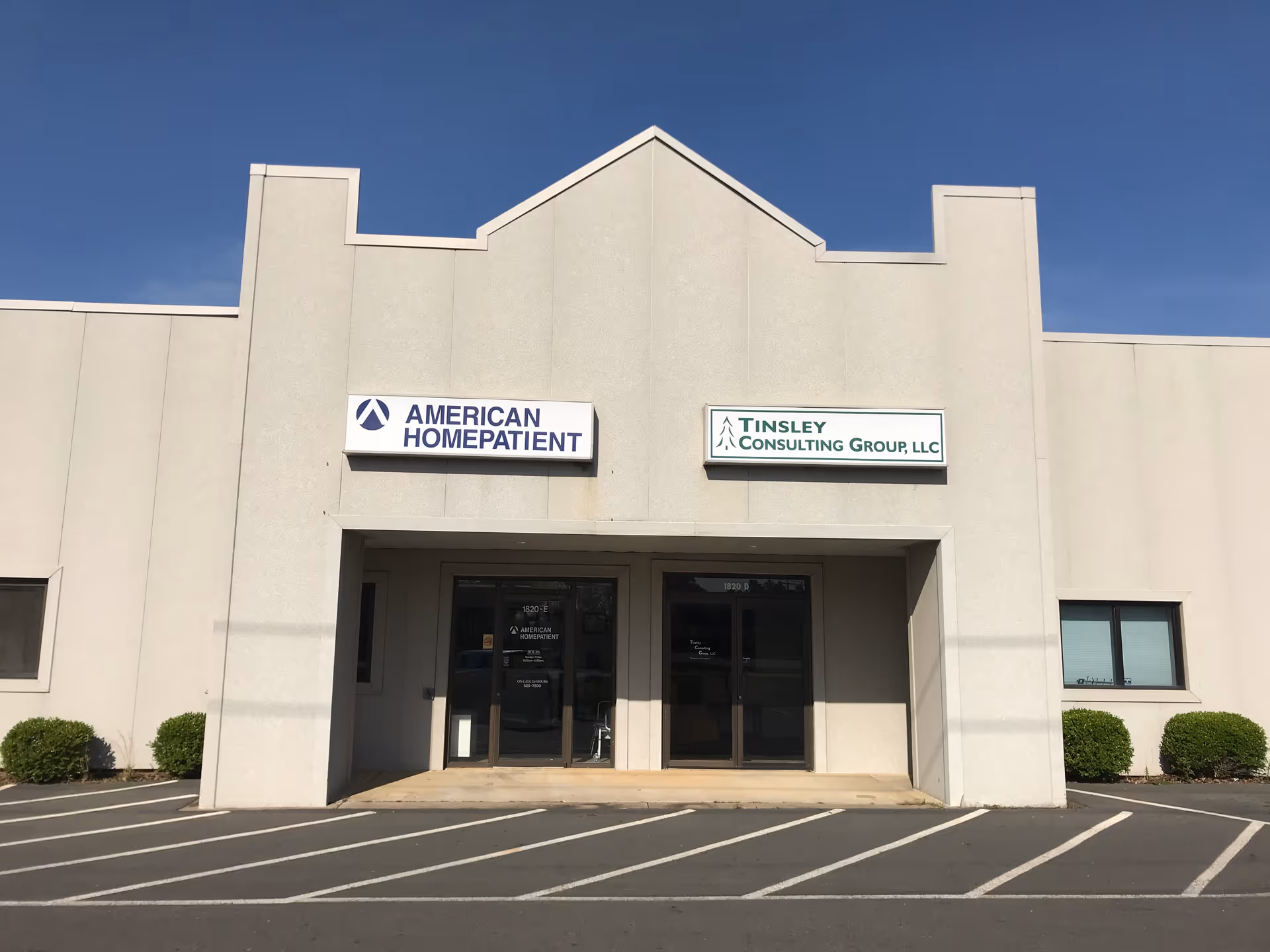 A beige commercial building facade with American HomePatient signage and glass entry doors.