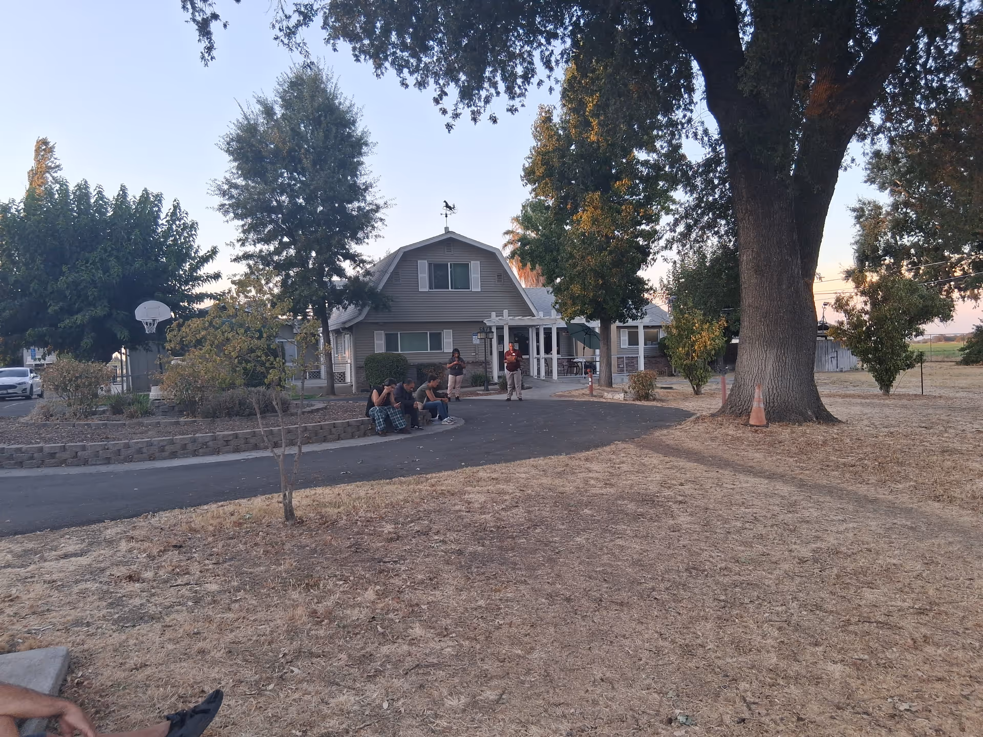 Exterior view of Enclave at The Delta with residents gathered outside near the entrance.