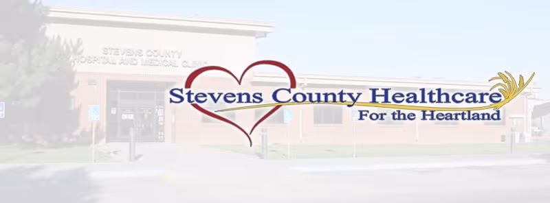 Front exterior view of Stevens County Hospital with entry doors and lawn.