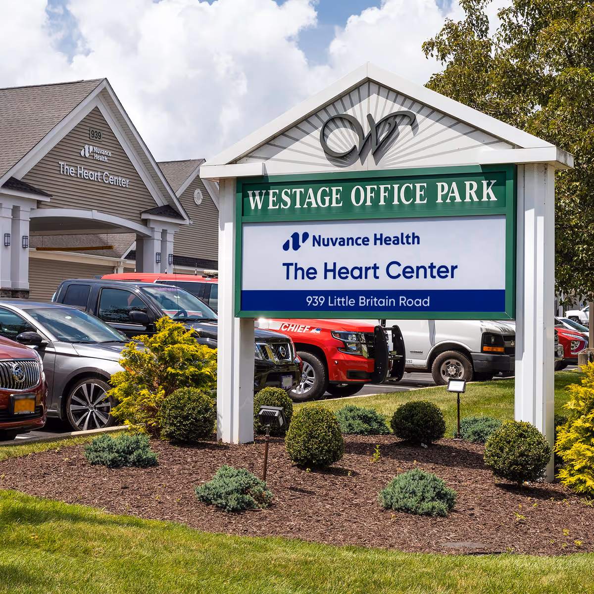 Exterior view of a building with a sign for The Heart Center at Westage Office Park.