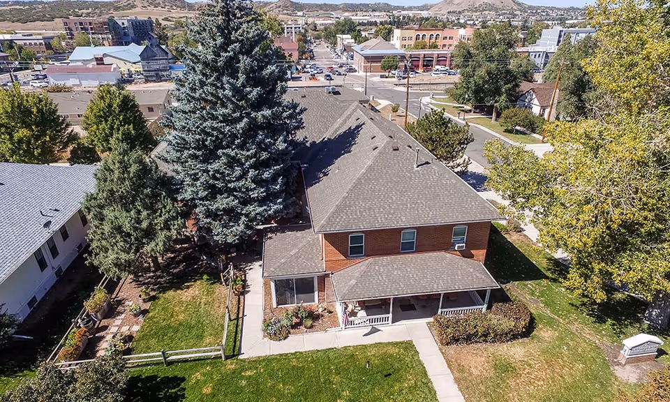 Aerial view of Cantril House Assisted Living exterior with trees, lawn, and sidewalk.