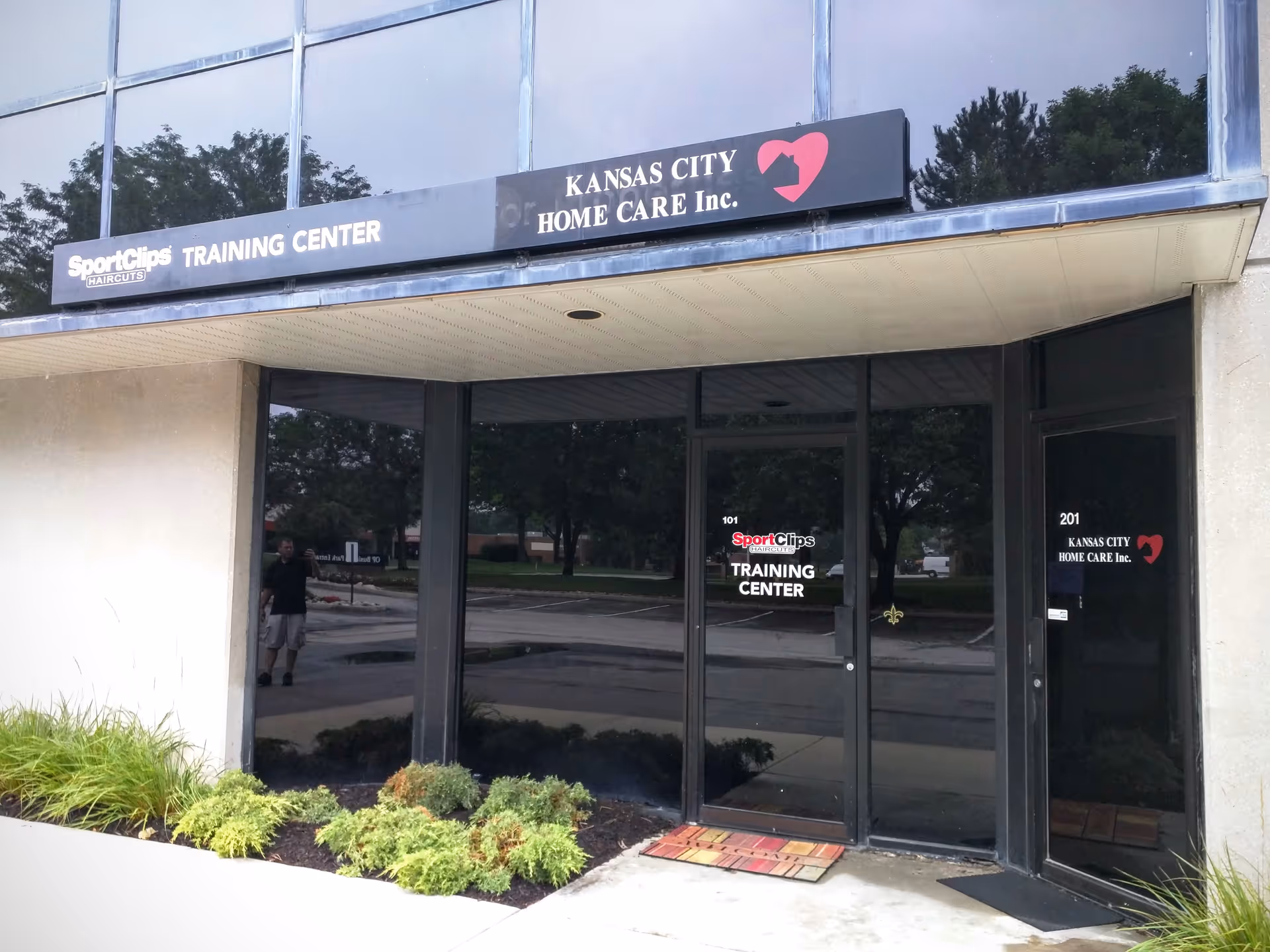 Exterior storefront entrance with Kansas City Home Care Inc. signage and glass doors