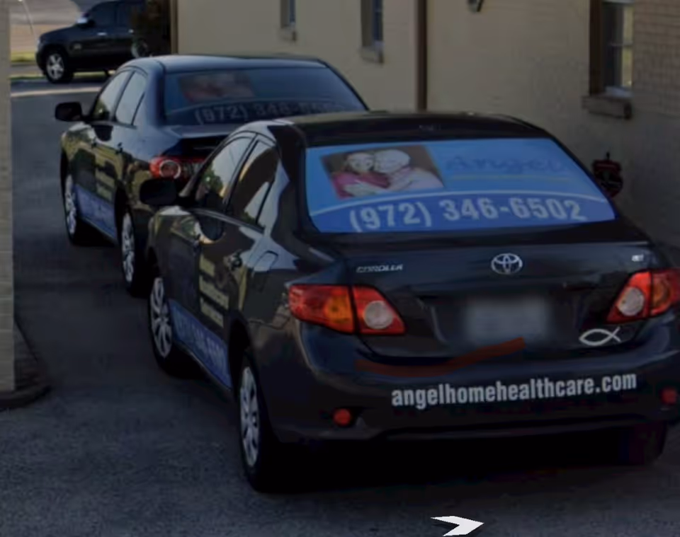 Two dark sedans with angelhomehealthcare signage parked outside a facility.