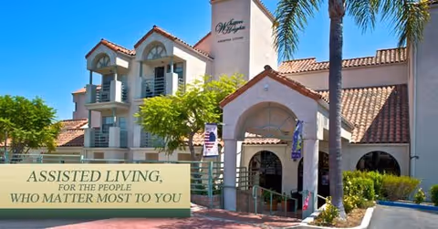Exterior view of Whitten Heights senior living facility with banner and palm trees.