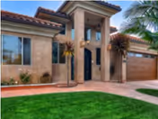 Front view of Meadowlark Gardens VII senior living facility with palm trees and entry columns.