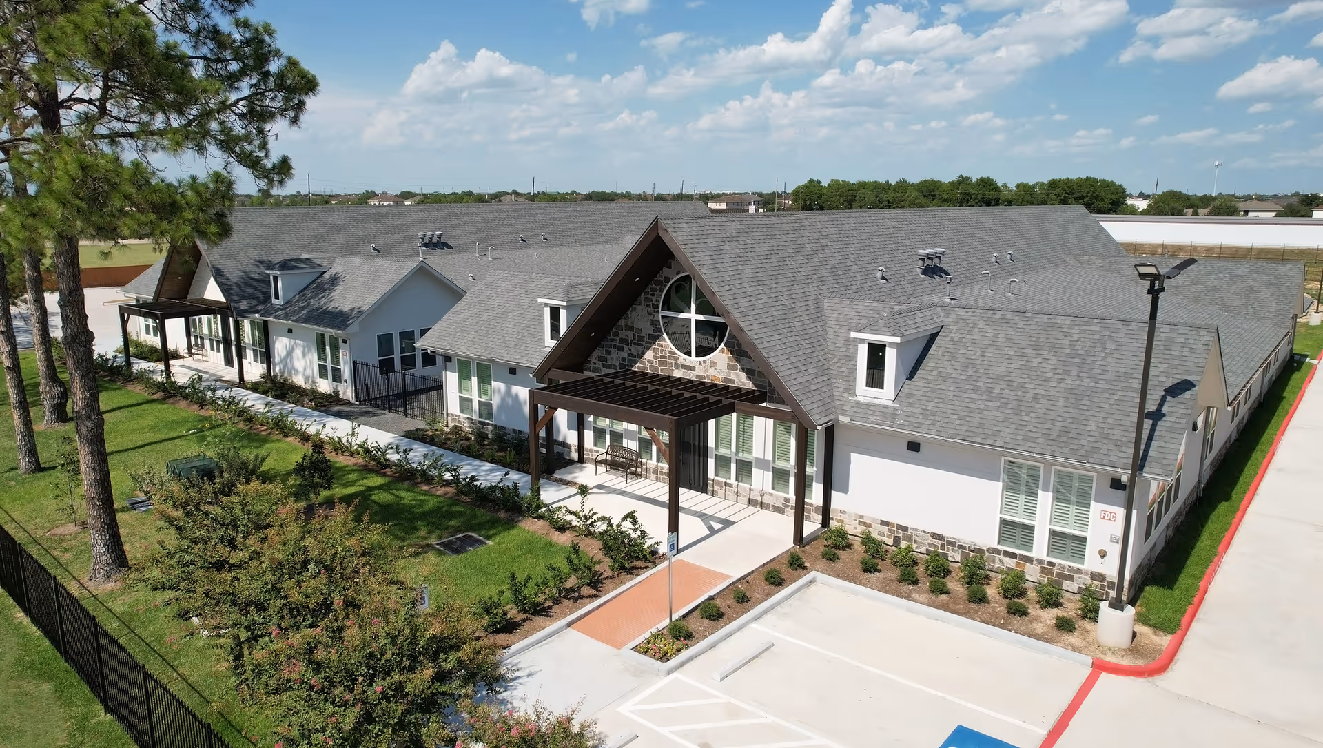 A single-story senior living facility with a peaked entrance and manicured landscaping.