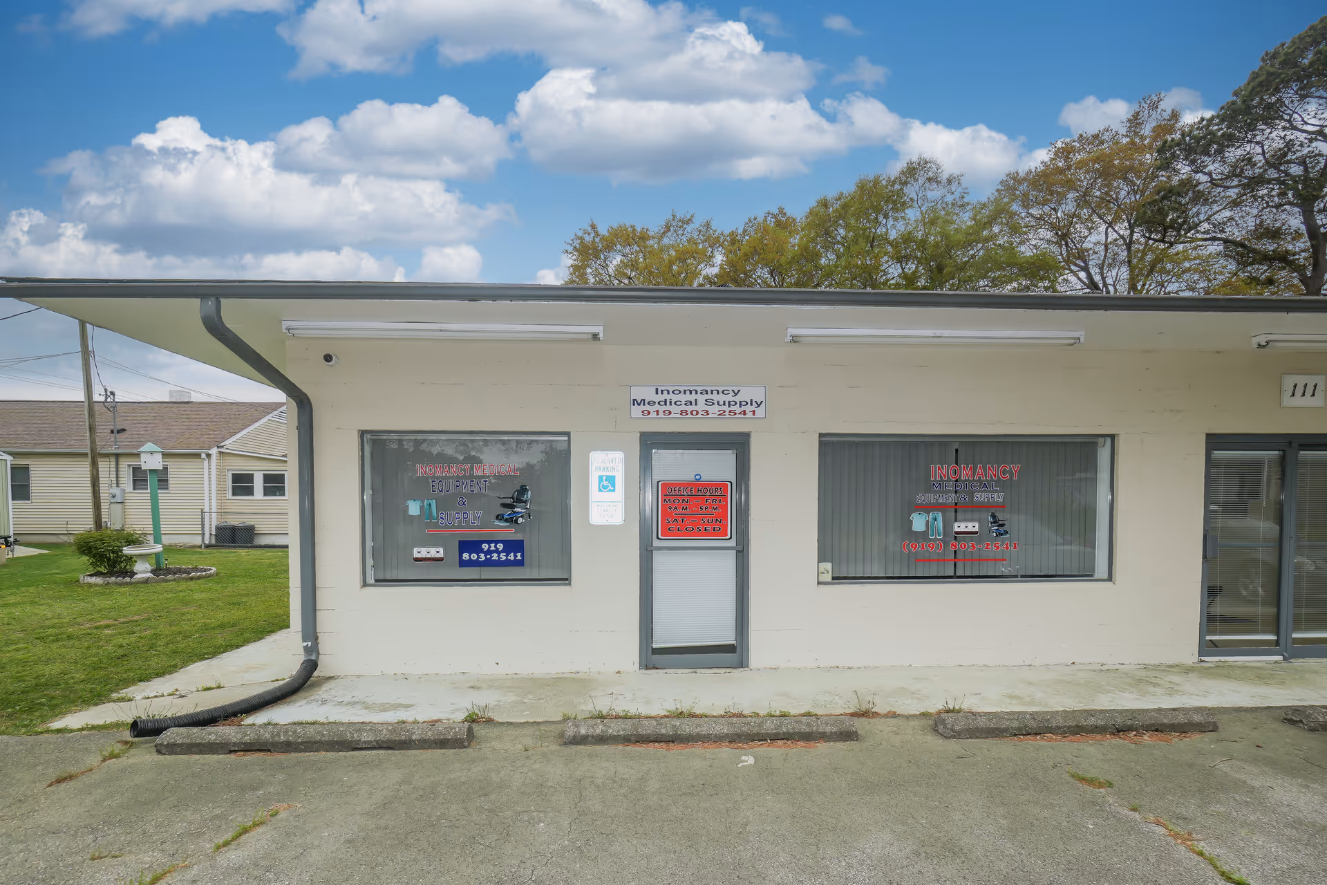 A single-story beige storefront with two windows and a central door labeled Inomancy.